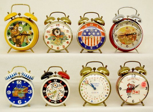 1960's-1970's Group of 8 Bell Top Alarm Clocks: Group of 8 Bell Top Alarm Clocks: late 1960's-70's. Harris Bank Lion; Stars & Stripes; Linden playing cards; Forestville drum set; 1972 Pakter alphabet teacher; Lux Go Big Red, Neb. Big 8 Conf.; Chine