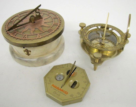 3 Sundial Clocks w/Compass: 3 Sundial Clocks w/Compass: 1.) Niamid retractable sundial with compass and sundial; Phiser; octagon; 3". 2.) London adjustable sundial and compass; 4 1/2". 3.) Wind up revolving sundial; brass, coppe