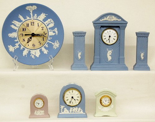 5 Wedgwood Clocks & Pair of Candlesticks: 5 Wedgwood Clocks & Pair of Candlesticks: assortment of Wedgwood clocks with quartz and battery movements; 3 blue, 1 green and 1 lavender; plus a pair of candlesticks. Largest 9 1/2" All items sell As