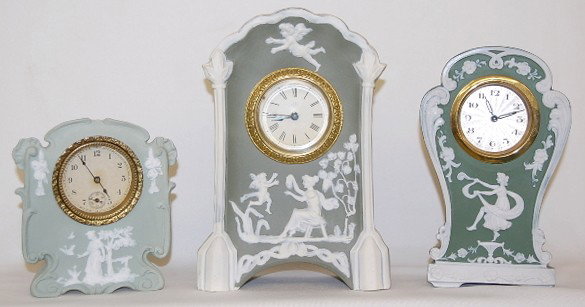 Group of 3 Green Jasperware Dresser Clocks: 3 Green & White Jasperware Clocks: 1.) Ansonia lady and cupids with grapevine #8769 on back; 30 hour movement; 7 3/4". 2.) Lady with birds and flower rosettes; #8340 on bottom; unmarked works; with se
