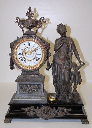 Ansonia "Poetry" Statue Clock: Ansonia "Poetry" Statue Clock: black iron base; bronzed statue of a girl holding a book; double sunk porcelain dial with open escapement and marked Ansonia Clock Co. Patented; 8 day signed movement; t