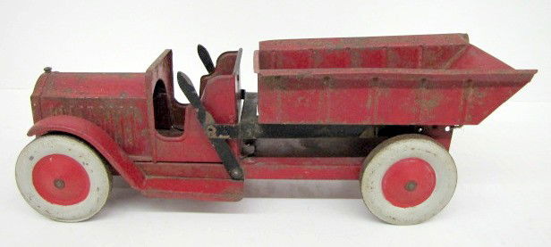 Early Pressed Tin Structo Toy Dump Truck, Works: - Early Pressed Tin Structo Toy Dump Truck: marked on grill; metal wheels; original paint; dumping mechanism works. (Paint is scratched and flaking.) In as is as found played with condition. All items