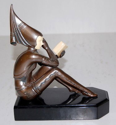 Bronze Art Deco Statue on Marble Base, 7 1/2": Bronze Art Deco Statue on Marble Base, 7 1/2": not marked; made in the fashion of French artists; a figure in a futuristic outfit, reading a book. 7 1/2" x 6" All items sell As Is, Where Is, no guaran