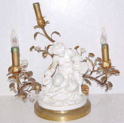 Capodimonte Lamp w/Pan Type Figure, 16": Capodimonte Lamp w/Pan Type Figure, 16": marked with N and crown; depicts half human and half goat mother with 2 children; has 3 metal branches with plastic flowers and candlestick light holders. No c