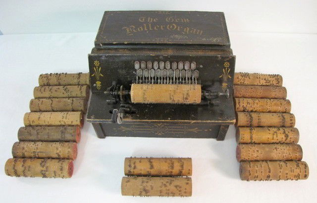 The Gem Roller Organ & 17 Rolls: The Gem Roller Organ & 17 Rolls: stenciled wood and painted case; bellows intact; appears complete, but does not play; has 17 music rolls. (Some wear to case; stenciling still nice.) 8" x 14 1/4" All