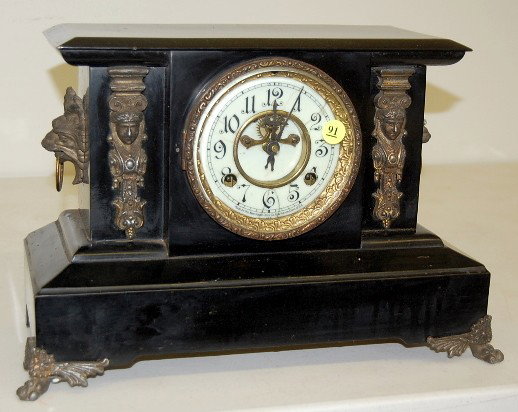 New Haven Iron Case "Fayette" Mantle Clock: New Haven Iron Case "Fayette" Mantle Clock: 8 day time and strike; hour and half hour gong strike; 4 1/2" marked porcelain double sunk dial with visible escapement; has pendulum; no key; black iron ca