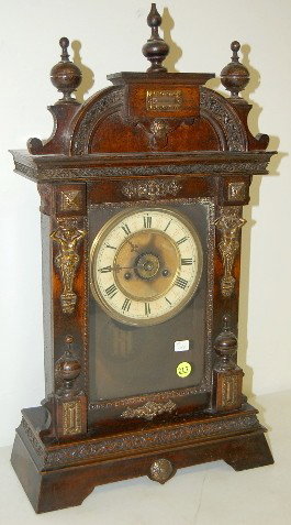 Junghans Metal Mounted Shelf Alarm Clock: Junghans Metal Mounted Shelf Alarm Clock: time, strike and alarm; 5" painted tin dial with Roman numerals; has pendulum; no key; plain door; not tested for running condition. (Center dial discolored; 