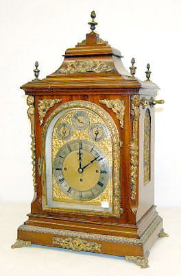 Ornate English 3 Train 8 Bell Bracket Clock: Ornate English 3 Train 8 Bell Bracket Clock: time, strike and Westminster chime; 4 silver dial face with ornate decoration; 11" face; beveled glass; case with cast metal floral finial; flower basket; 