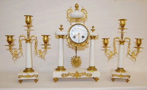 French A.D. Mougin Marble Garniture Set: French A.D. Mougin Marble Garniture Set: 8 day time and strike; 3 1/2" painted floral porcelain dial; has key and pendulum; marble with gilt metal trim and feet; matching 3 candle candelabras. (Not ru