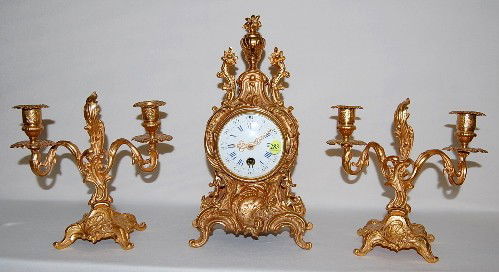 S. Marti French 3 Piece Dore Garniture Set: S. Marti French 3 Piece Dore Garniture Set: time only; 3 1/2" porcelain dial with Arabic and Roman numerals; has pendulum; dore case with matching 2 candelabras; movement marked S. Marti & Ang ne Mon