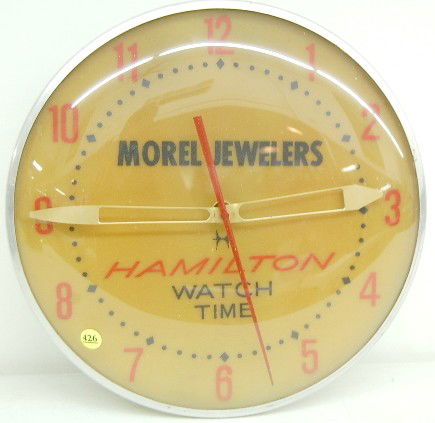 Electric Advertising Clock "Hamilton Watch Time": Electric Advertising Clock "Hamilton Watch Time": from Morel Jewelers; convex glass; lights and running. 15" diameter All items sell As Is, Where Is, no guarantees of any kind. We accept Mastercard &