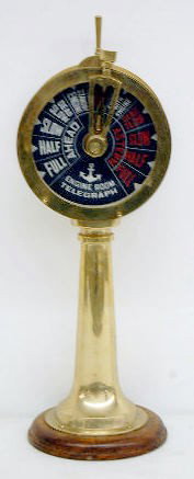 Brass Ships Standard, SS. Titanic Liverpool Clock: Brass Ships Standard, SS. Titanic Liverpool Clock: quartz movement runs; bell strike when moving gears; mounted on wood base; double sided black & white dials. (Second hand is broken.) 20" T All items