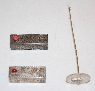 Sterling Hat Pin & 2 Silver Lipsticks: Sterling Hat Pin & 2 Silver Lipsticks: 1.) The hatpin has a half dollar sized top w/ engraved designs around a horse's head in high relief; it is marked Arnold-Sterling and is on a 6" shaft. 2. & 3.) 