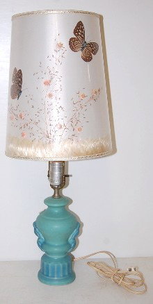 Van Briggle Pottery Electric Lamp w/ Shade: Van Briggle Pottery Urn Shaped Electric Lamp: Van Briggle mark by the cord; green to blue glaze; original Van Briggle butterfly shade. (No finial and no felt on bottom.) 23"T w/ shade. All items sell 