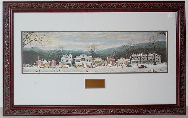 N.Rockwell "Stockbridge Main Street at Christmas": Rockwell "Stockbridge Main Street at Christmas": Framed print depicting a main street with holiday decorations, people and cars; artist signed Norman Rockwell; metal tag reads "Stockbridge Main Street