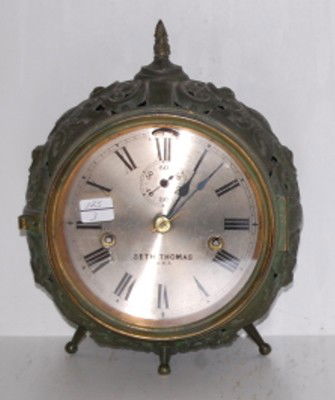 Seth Thomas Ornate Iron Shelf Clock: Seth Thomas Ornate Iron Shelf Clock: T & S; round iron floral clock with seconds bit; 4 legs; 5 1/2" dial. 10". This lot is in rough, as is, as found condition. All items sell As Is, Where Is, no guar