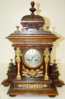 Antique Lenzkirch Bronze & Walnut Shelf Clock: Antique Lenzkirch Bronze & Walnut Shelf Clock: w/3 winged cherubs; ornate trim; lady heads on side; engraved silver dial; T&S. 19" All items sell As Is, Where Is, no guarantees of any kind. We accept 