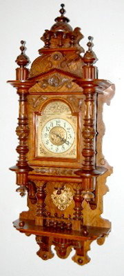 Ornate Antique German Open Well Swinger Clock: Ornate Antique German Open Well Swinger Clock: carved walnut case; ornate pendulum; movement is marked 1 million with wings. 48" This item ships F.O.B., which means you, the buyer, must make all packi