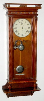 Seth Thomas "Suez" Carved Wall Regulator: Seth Thomas "Suez" Carved Wall Regulator: walnut case; T&S w/ seconds bit; bell strike; Damascened pendulum. (Bottom finial damaged; minor trim piece missing.) 44" This item ships F.O.B., which means