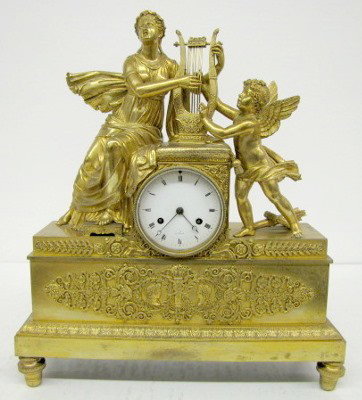 French Empire Dore Bronze Lady & Cherub Clock: French Empire Dore Bronze Lady & Cherub Clock: porcelain dial marked "a Paris"; unmarked movement; time and strike; has pendulum; lady playing harp with cupid; Roman heads and flame applique on front;