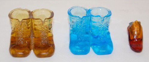 2 EAPG Double Boots & Thimble Holder Shoe: 2 EAPG Double Boots & Thimble Holder Shoe: 1.) The double boots were made by King Sons & Co.; 1880's; one amber, one blue, both 1 3/4"T. (Both are chipped on the boot rims and have as made roughness.)