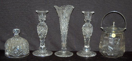 5 Clear Cut Glass Items, Trumpet Vase +: 5 Clear Cut Glass Items: 1.) Trumpet vase. 2.) Pair of candlesticks with airlock stems. 3.) Butter dish cover with hobstars, fine cut and notches. 4.) Cracker jars with stars, notched garland and fans