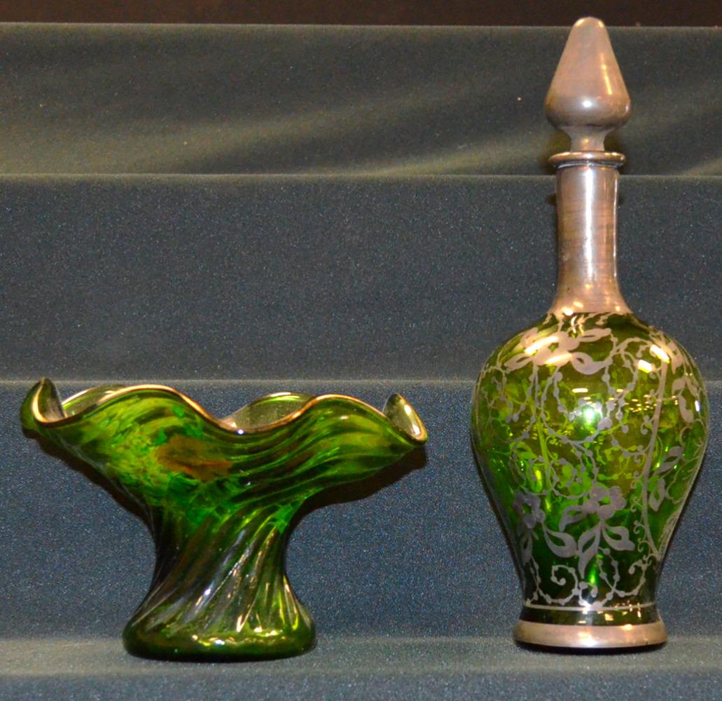 Glass Decanter and Vase: Glass Decanter and Vase. The green glas decanter has original stopper and has silver resist floral and other motif. 11 1/2" total size. The swirl pattern vase has enamel floral and is 4 3/4"T x 7 3/4"