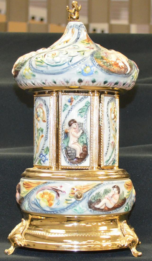 Musical Vanity: Musical Vanity Carousel for lipstcik, Wind the bottom key and swiss music. Box play a tune and the 6 panels open to reveal your lipstick. Not antique. 13" Tall. Marked Gold leaf made in Italy.
