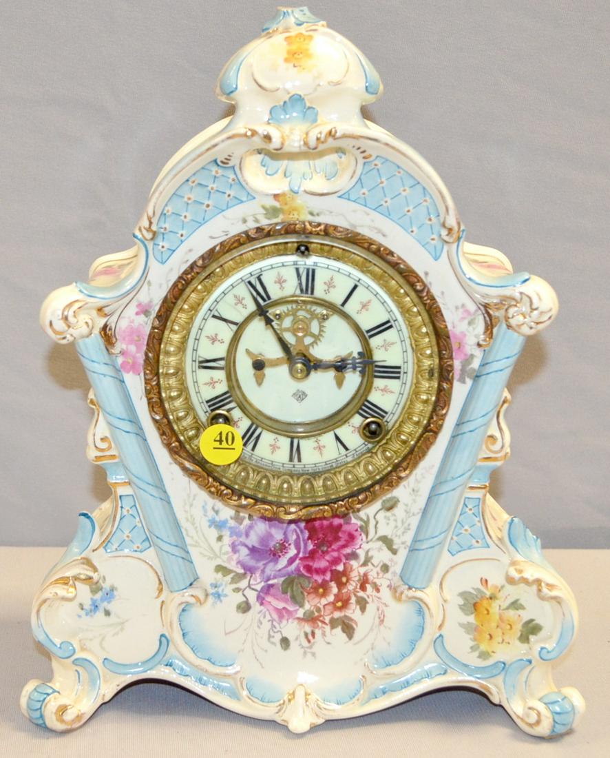 Ansonia Royal Bonn LaRhone China Mantel Clock: Ansonia Royal Bonn LaRhone China Mantel Clock. 8 Day Time strike with a 4", 2 pc dial. Floral with light blue trim. 13"T. Top curl chipped off, outer dial ring has a hairline. Clock runs good.