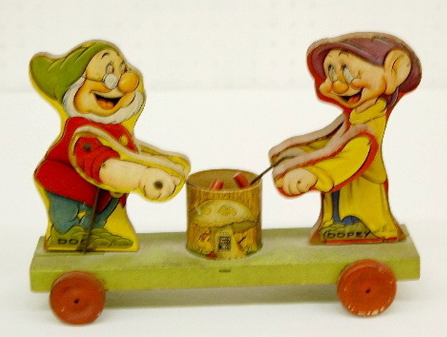 Fisher Price W.D. Ent. Doc & Dopey Pull Toy: Fisher Price#770 W.D. Ent. Doc & Dopey Pull Toy: dated 1937. 8 1/2" x 12". (Paper torn on one side of Dopey; corners gone on the other side; no pull string; some edge wear.) In as is found played with