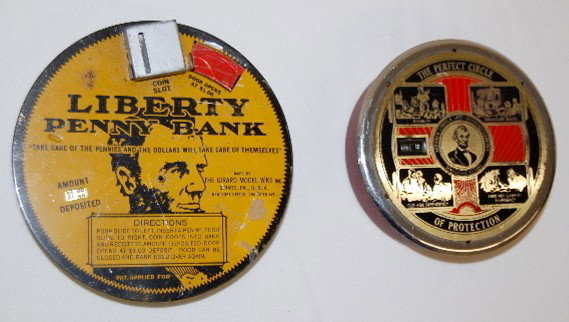 2 Tin Litho Lincoln Penny Banks: 2 Tin Litho Lincoln Penny Banks: 1.) The Cada Co. Abraham Lincoln Life Insurance Company. (Some wear.) 2.) Girard Model Works Liberty Penny Bank; tracks amount deposited. (Some scratches and surface w