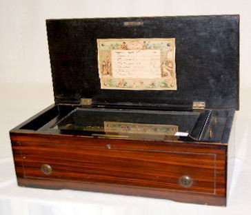 Antique Swiss Cylinder Music Box, Six Tune: Swiss Cylinder Music Box, Six Tune: with an 8 1/4" comb; playing parts are intact; internal crank; with original, hand written tune list; no maker's information available. Case is 5 1/2" T x 16 1/2" W
