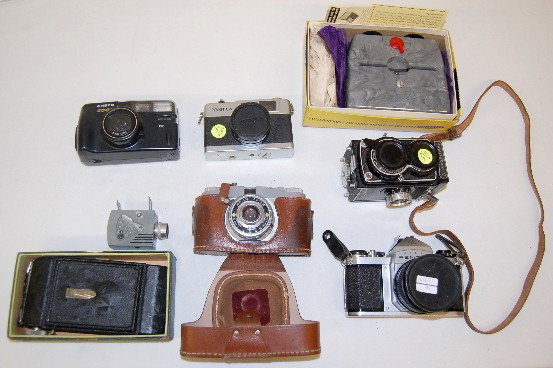 8 Old Cameras & Related Items: 8 Old Cameras & Related Items: Pentax No. 914313; Sawyers mark IV; Spartus; Yashica 35-ME; Ansco zoom; minute 16; metro finish; last is a sterling inocular stereo view. All items sell As Is, Where Is,