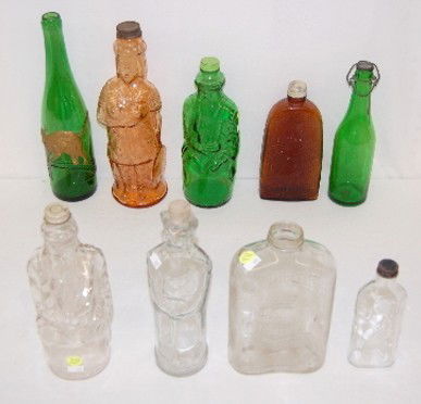 9 Old Bottles, Green, Amber, and Clear: 9 Bottles, Green, Amber, and Clear: 1.) Zeller Schwarze Katz bottle; 12 1/4" Tall. 2.) Plain green with stopper; 10" Tall. 3.) Green bearded man bottle; 9 3/4" Tall. 4.) Clear Rat Poison with rat on t