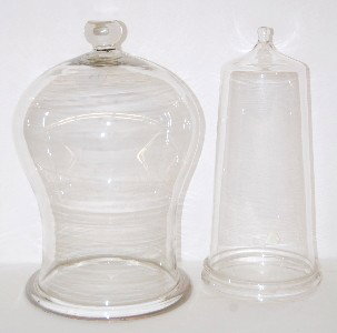 2 Glass Domes with Top Knobs, Clear: 2 Glass Domes with Top Knobs, Clear: 1.) Largest has curved sides with heavy glass ring around the bottom; 15" x 9 1/2" Diameter. 2.) Smaller has tapered sides going from wider at the bottom to narrow