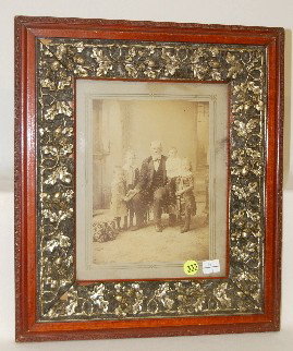 Antique Picture Frame with Acorn Decor: Antique Picture Frame with Acorn Decor: the gold painted acorn and oak leaf designs are made of gesso (plaster); contains an old photo of a man with his grandchildren. The frame is 15 1/4" x 13 1/4".