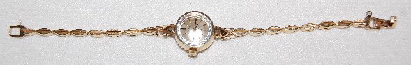 Omega Ladymatic 14K Wrist Watch & Band: Omega Ladymatic 14K Wrist Watch & Band: 17J, Unadjusted, S.N. 27091818, Model or Garde 660. The silver dial has gold and black hands & markers. In a Ross for Omega No. SS5819 over 70646. The 14K yello