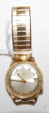 Bulova Accutron GF Wrist watch, Circa 1969: Bulova Accutron GF Wrist watch, Circa 1969: No. G89593; silver dial has all gold features; day and month display at the 3. A stem winder is at the 4; marked on back along with general information is t