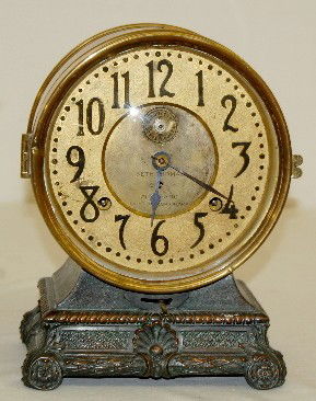 Seth Thomas "Grand" 8 Day Long Alarm Clock: Seth Thomas "Grand" 8 Day Long Alarm Clock: has pendulum and key; marked Seth Thomas painted metal face; marked ST brass movement; polished brass case on a white metal base. Running. (Small amount of