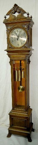 Seth Thomas Oak Carved Hall Clock No. 21: Seth Thomas Oak Carved Hall Clock No. 21: with seconds bit; silvered dial ; brass trim, pendulum and weights; beveled glass; claw feet. Running and striking at this time. The strike is on one or more