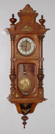 Gustav Becker Carved RA Clock: Gustav Becker Carved RA Clock : porcelain chapter ring with embossed center; TO; castle decorated pendulum; carved case with brass decorations including old man of the mountain face; 285879. (Wrong bo