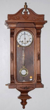 Lenzkirch Carved German RA Wall Clock: Lenzkirch Carved German RA Wall Clock: has pendulum and key; porcelain dial; T & S; marked Lenzkirch A. G. U. 26 Serial # 360152. (Door frame cracked; veneer damage; replaced top.) Not tested. 37" All