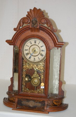 New Haven Walnut "Occidental" Parlor Clock: New Haven Walnut "Occidental" Parlor Clock: Made in U.S.A. paper dial; T & S with alarm; has pendulum and key; gilt decorated door. (Not running; mirrors are spotty; no side statues.) 24" All Items Se