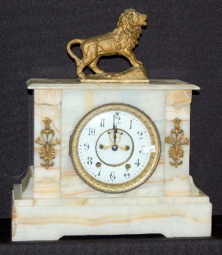 Seth Thomas Onyx Mantel Clock W/ Lion Statue: Seth Thomas Onyx Mantel Clock W/ Lion Statue: porcelain dial with visible movement; T & S; marked Seth Thomas works; has pendulum; has a small size metal lion statue with it. Working. Clock 10" with s
