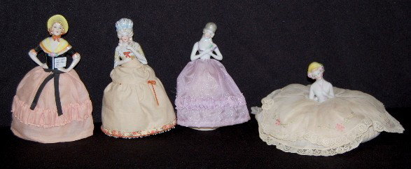 4 Porcelain Pin Cushion 1/2 Dolls W/ Cushions: 4 Porcelain Pincushion 1/2 Dolls W/ Cushions: the short one has a spread out skirt with lace trim; the taller ones have fancy hairdos and open arms; one has a hat and one has a fan. No condition probl