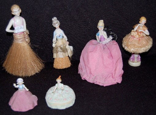 6 Pincushion & Whisk Broom Porcelain 1/2 Dolls: 6 Pin Cushion & Whisk Broom Porcelain 1/2 Dolls: One pincushion is in a metal rocking chair; one is a ballerina; 2 very small pin cushions; one whisk broom is a lady with an open arm; the other whisk 