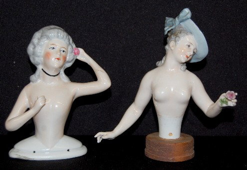 2 Large Porcelain 1/2 Dolls For Pin Cushions: 2 Large Porcelain 1/2 Dolls For Pin Cushions: both have gray hair; one has a gray hat, it is not marked; the hatless one is marked Germany. No condition problems. Tallest 5 1/2".