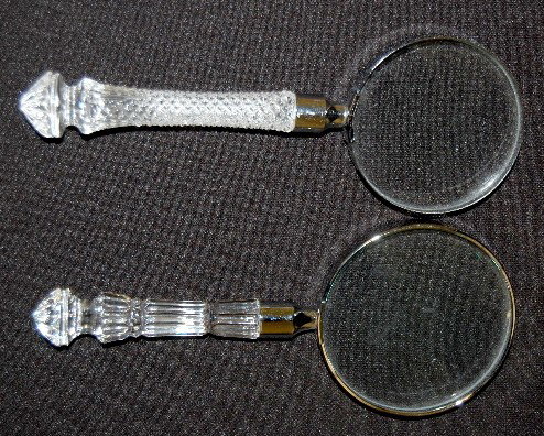 2 Waterford Crystal Magnifying Glasses: 2 Waterford Crystal Magnifying Glasses: 1.) Marked Waterford on metal base of glass; has a 4 section ribbed handle. 2.) Not marked; has a diamond point handle. No condition problems. 7" L.