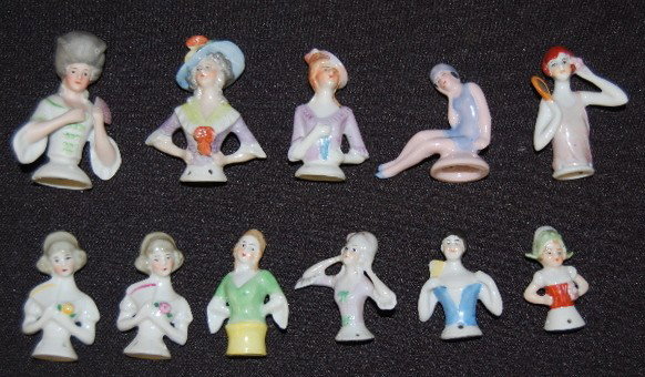 11 Porcelain 1/2 Dolls For Pincushions: 11 Porcelain 1/2 Dolls For Pincushions: none have cushions. One is a bathing beauty with a faint mark of Germany. No condition problems. Tallest 2 1/2".
