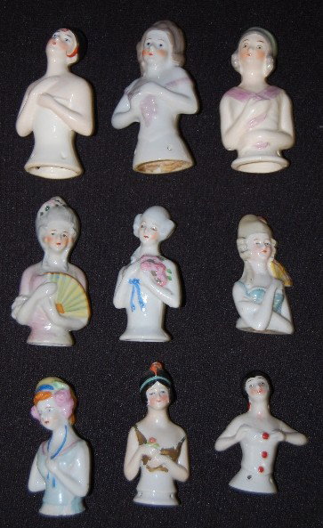 9 Porcelain 1/2 Dolls For Pincushions: 9 Porcelain 1/2 Dolls For Pincushions: none have cushions. No condition problems. Tallest 3 3/4".
